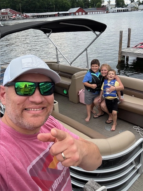 Greg Dorothy and his family on their pontoon.