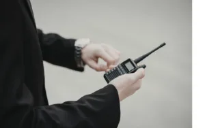 A person holding a handheld radio.