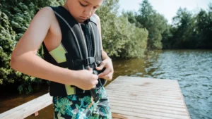 Child putting on life vest